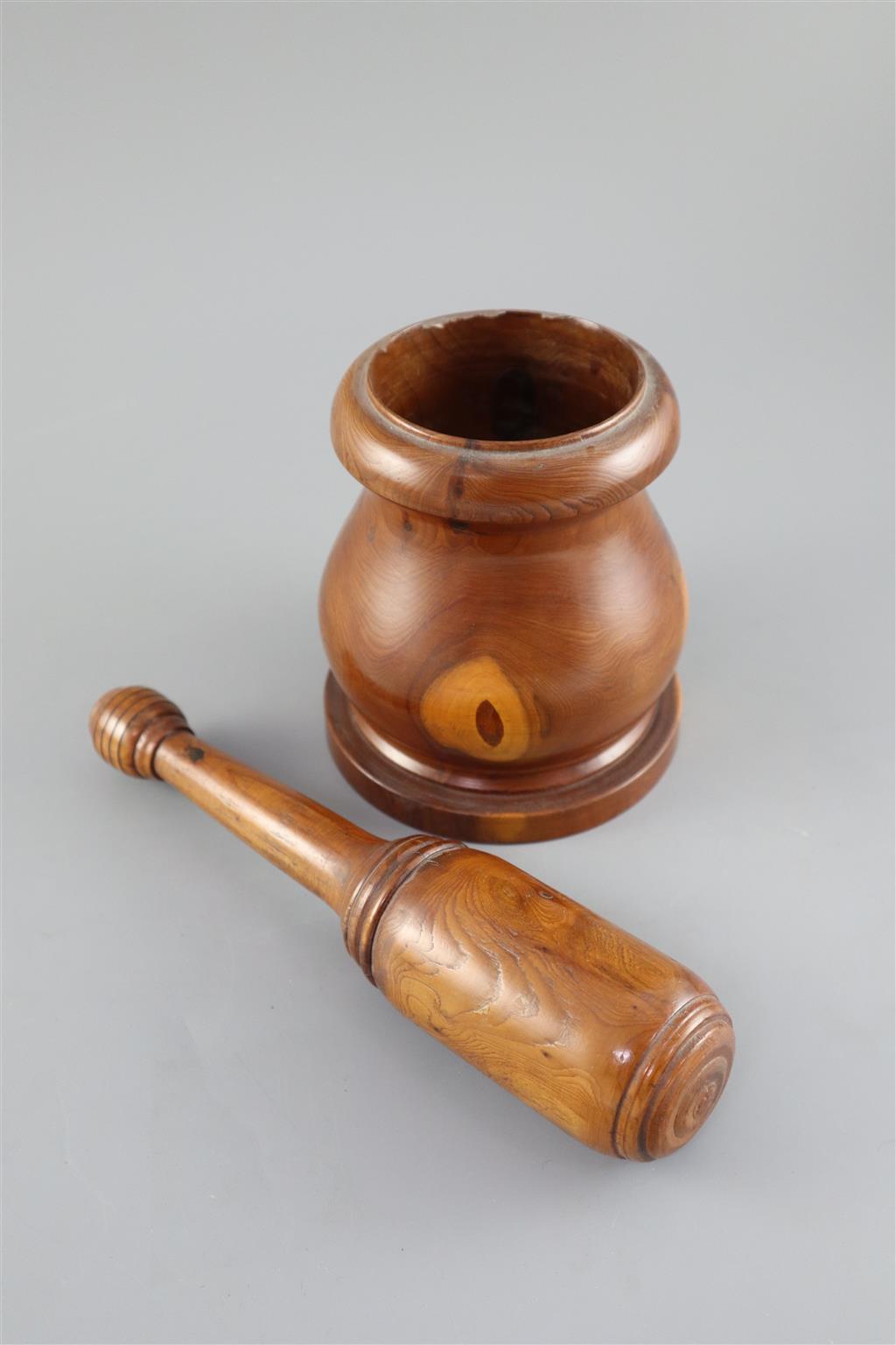 A late 18th / early 19th century turned yew wood pestle and mortar, pestle 9in. mortar height 5in.